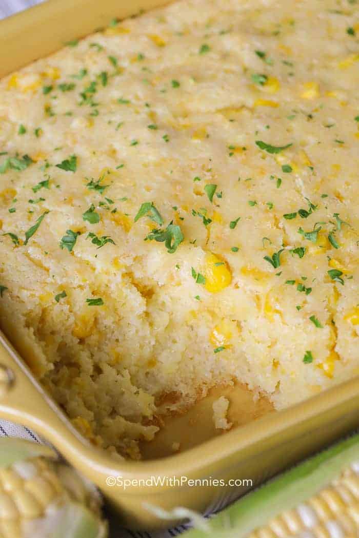 Baking dish of Corn Casserole with a serving taken out of it