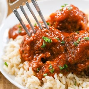 Lifting a Porcupine Meatball off plate with a fork