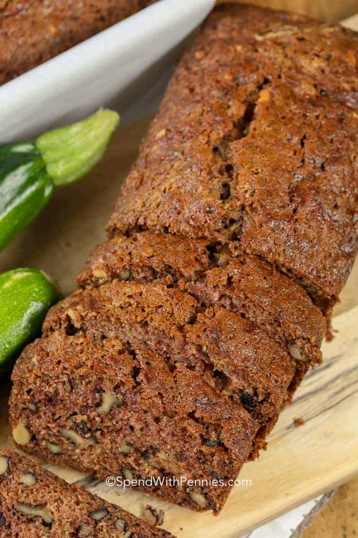 Sliced loaf of Zucchini Bread on a wood cutting board