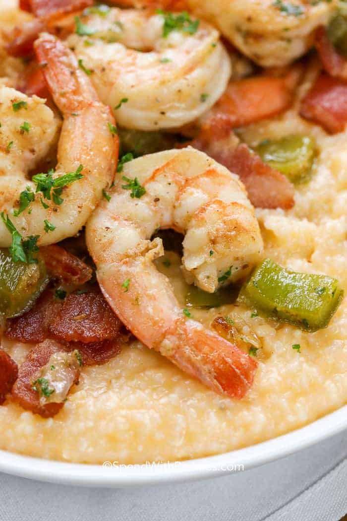 Shrimp and grits is a delicious southern-inspired dish. It combines tender shrimp with creamy corn grits for a flavorful meal. It's a popular choice if you’re looking for a comforting and tasty Southern treat! #shrimpandgrits #southern #recipe #grits #spendwithpennies Closeup of Shrimp and Grits