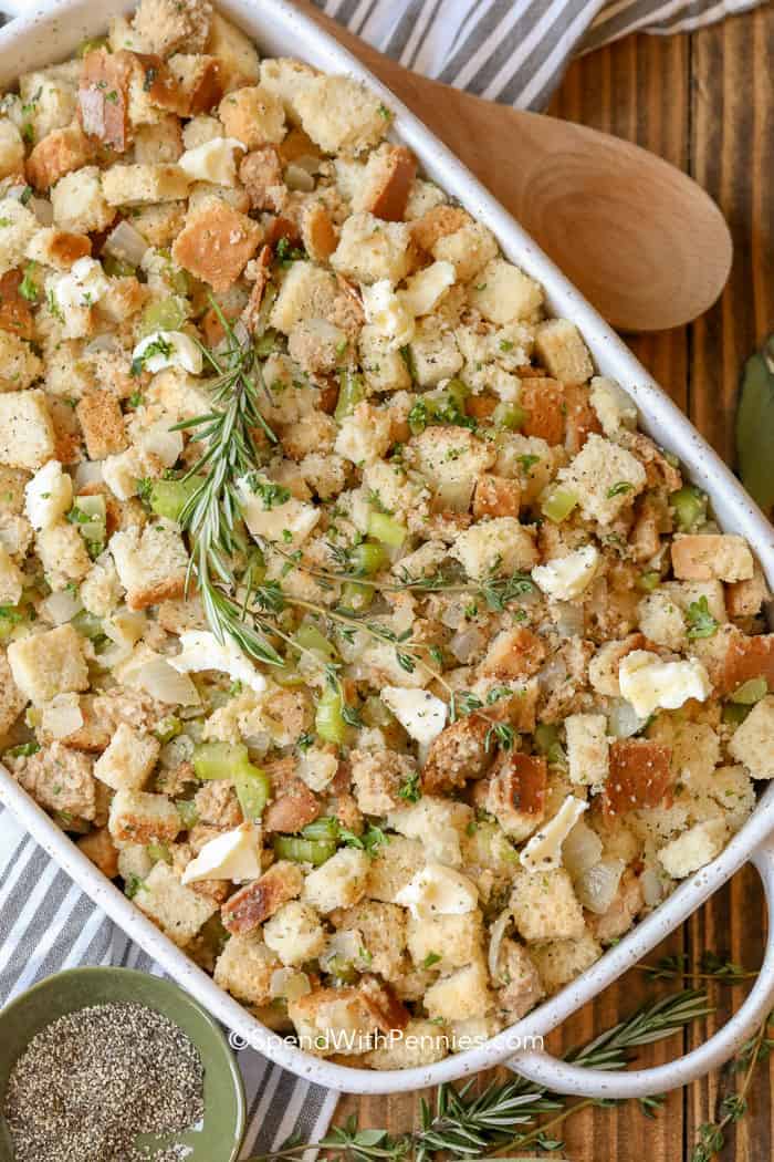 This classic stuffing recipe comes out perfectly moist and golden every time! It is turkey's best friend!#spendwithpennies #stuffing #stuffingrecipe #turkeystuffing #turkeydinner #thanksgiving Overhead shot of Homemade Stuffing in a baking dish