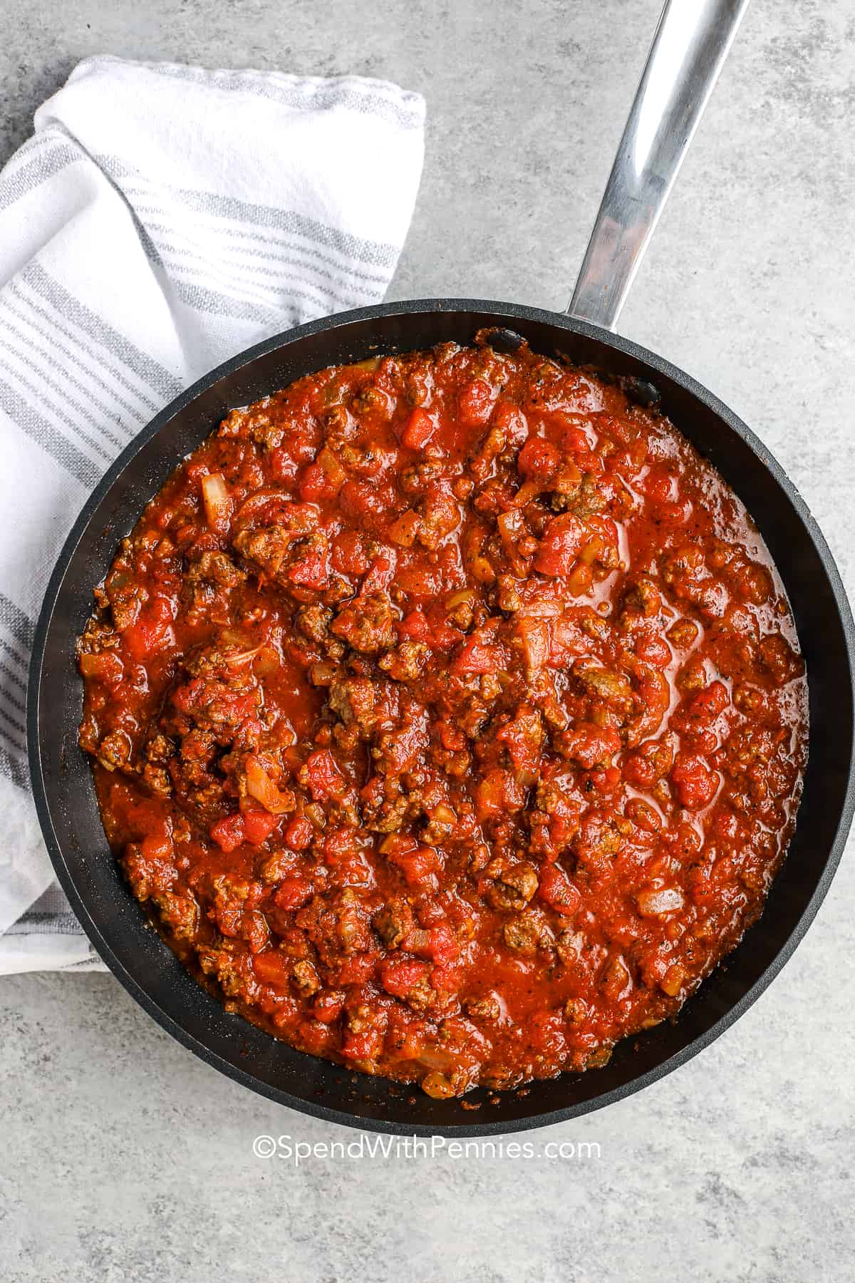 Hamburger casserole is a go-to recipe when you crave something hearty and satisfying. While not a soup or a bean dish, its tomato sauce, ground beef, and veggies form a comforting base. You can adapt by mixing in noodles, macaroni, or even rice. The golden top layer of cheese makes every bite rich, and adding cream or mushroom bits can elevate texture and flavor. #spendwithpennies ground beef sauce in a skillet for hamburger casserole