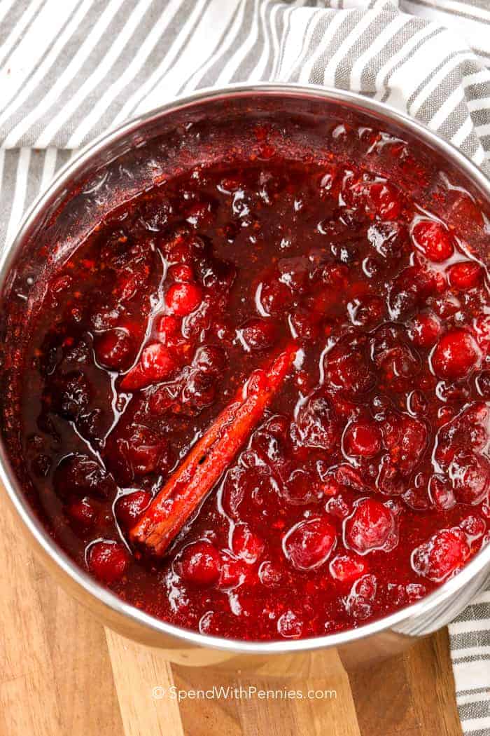 Simple and elegant, this homemade cranberry sauce is one of our favorite sides during Thanksgiving or the holidays. In just 15 minutes, this cranberry sauce with simple ingredients is ready to serve alongside all your holiday favorites. #cranberrysauce #homemade #thanksgiving #spendwithpennies Cranberry Sauce in pot with cinnamon
