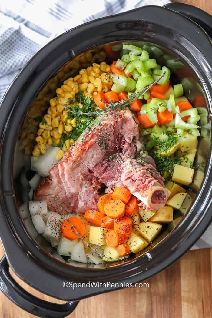 This Ham Bone Soup recipe is such a great mix of leftover ham, beans, and other amazing additions like fresh vegetables. It is the perfect way to use up any holiday ham! Just toss all the ingredients into the slow cooker and let it simmer away. Serve this easy soup recipe with your favorite buns or biscuits for a meal everyone will love. #spendwithpennies #hambonesoup #slowcooker #leftoverham ham bone soup no broth