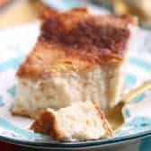 Sopapilla Cheesecake on a plate with a piece on a fork