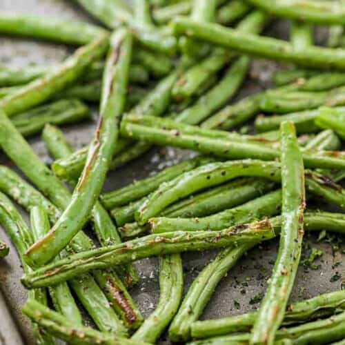Roasted green beans on a baking sheet