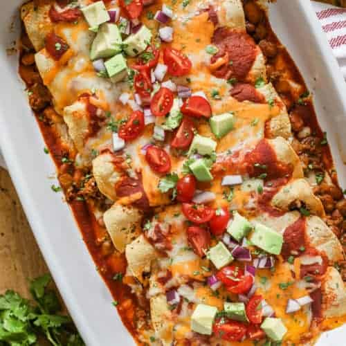 Ground Beef Enchiladas baked in a pan with toppings