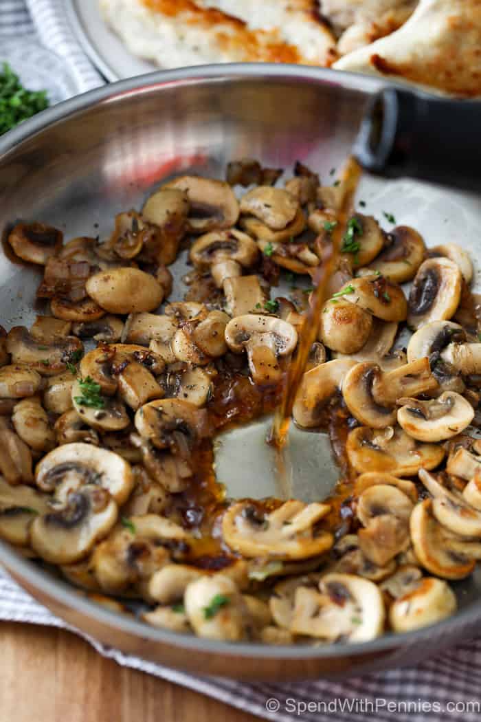 Chicken marsala ingredients in a bowl with liquid being poured in