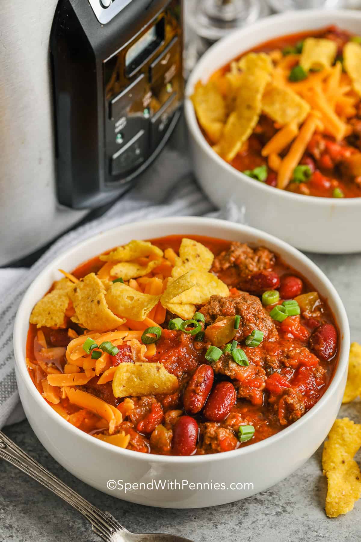 You definitely want to try this delicious Crockpot Chili recipe. The savory tomato sauce has a special ingredient that gives it an amazing flavor. You can use ground beef, go vegetarian, or create a white chili version. It's a simple dinner that requires minimal effort but delivers fantastic results! #crockpotchili #chili #crockpot #slowcooker #spendwithpennies crockpot chili in a bowl