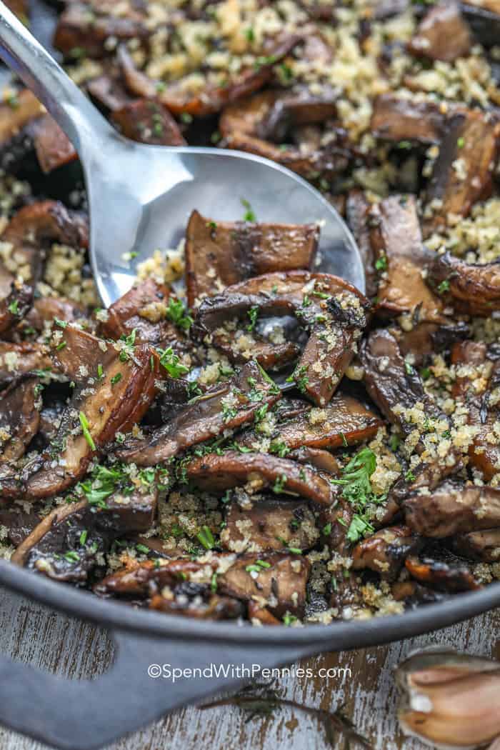 Spoon in a pan of Garlic Butter Portobello Mushrooms
