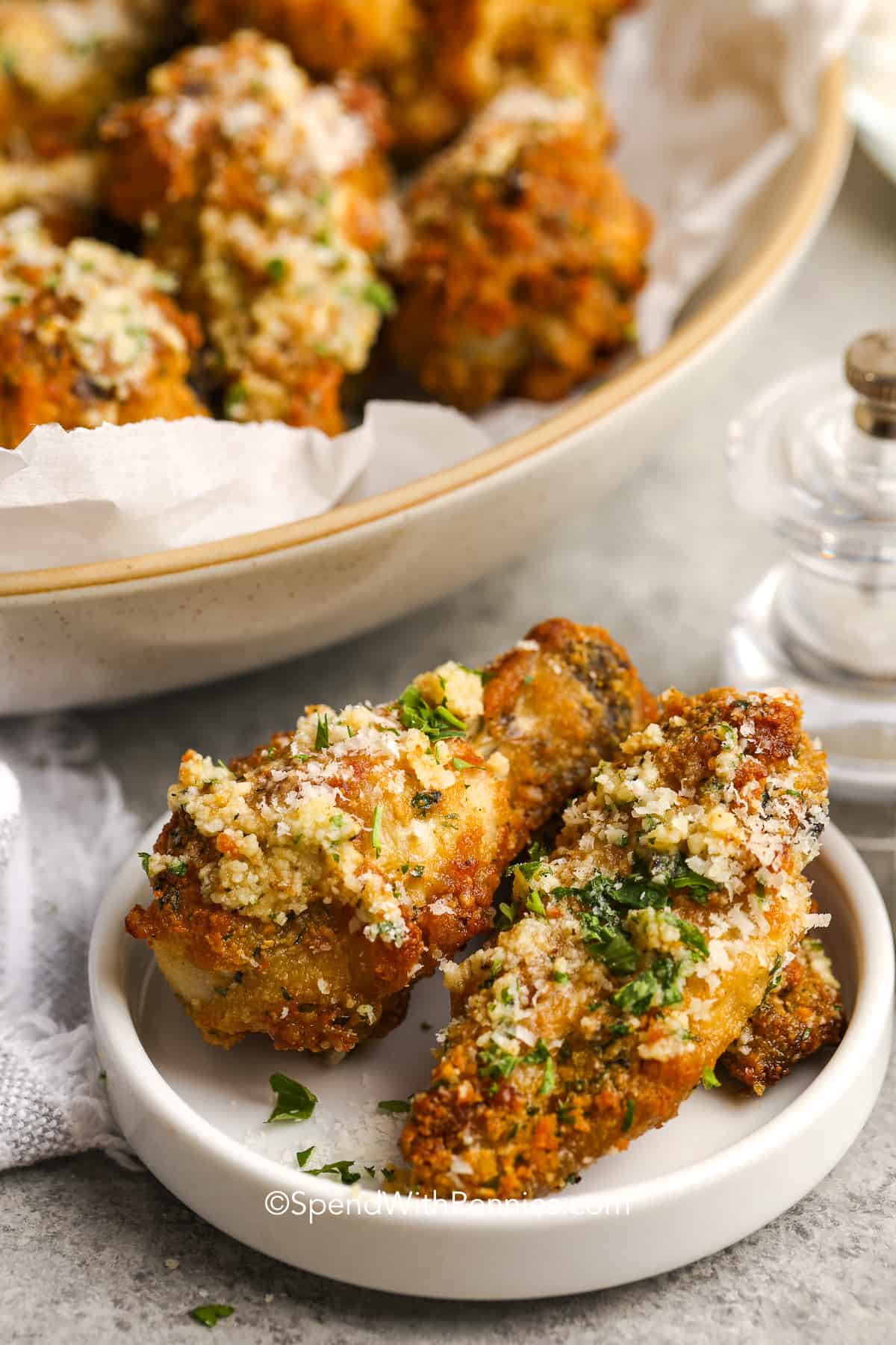 2 garlic parmesan wings on a plate.