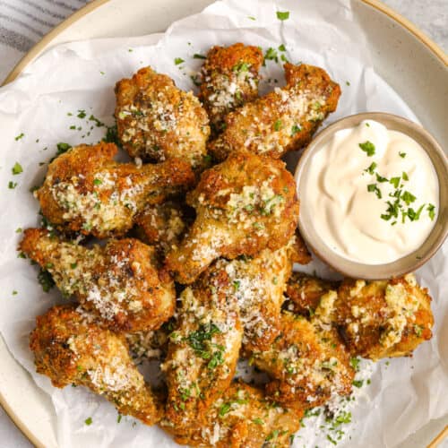 garlic parmesan wings with dip in a bowl