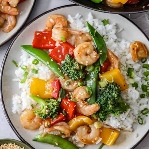 Shrimp stir fry on a plate with rice