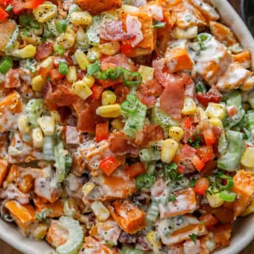 Sweet Potato Salad topped with corn and green onions