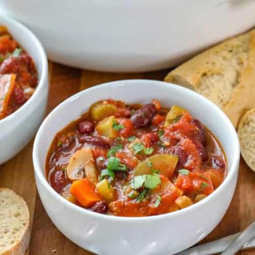 Vegetarian Chilli in a bowl with spoons and bread