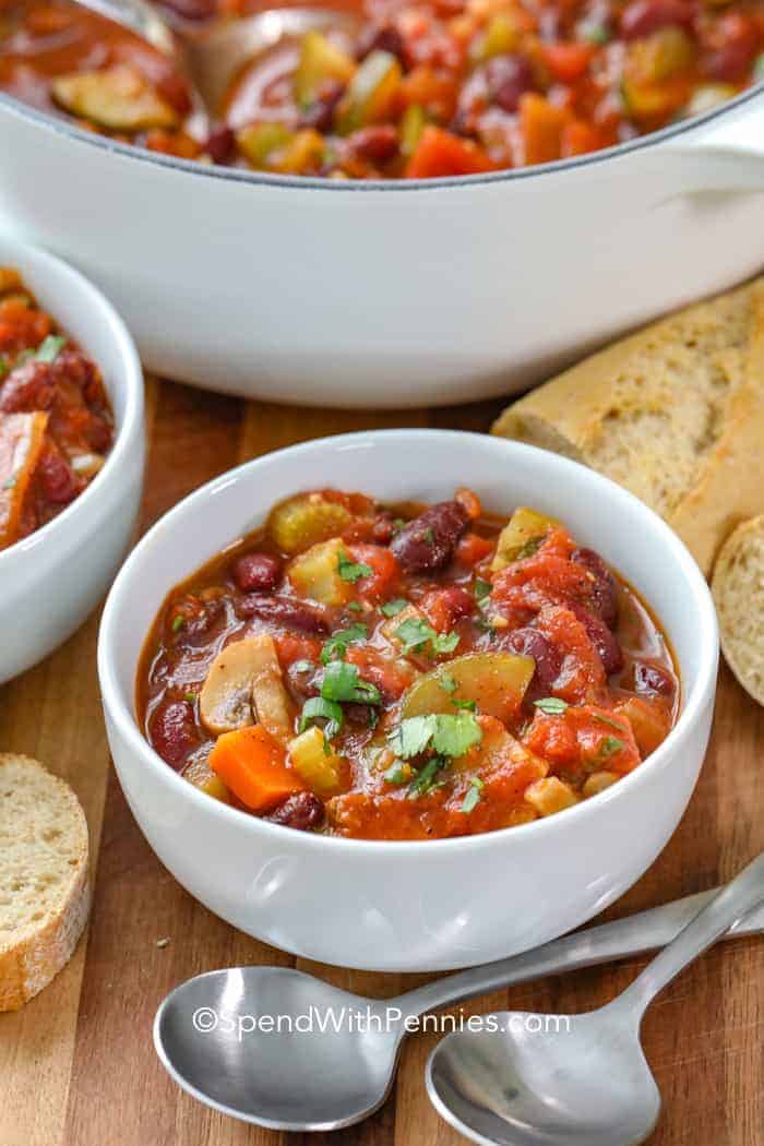 Vegetarian Chilli in a bowl with spoons and bread