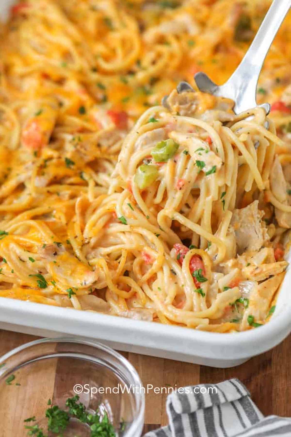 This easy cheesy Chicken Spaghetti casserole is made with shredded chicken, cheese, and spaghetti all in a homemade cheese sauce! Serve with some garlic bread and a side salad for the perfect meal. #spendwithpennies #chickenspaghetti #spaghetti #kidfriendly #maindish chicken spaghetti in a baking dish