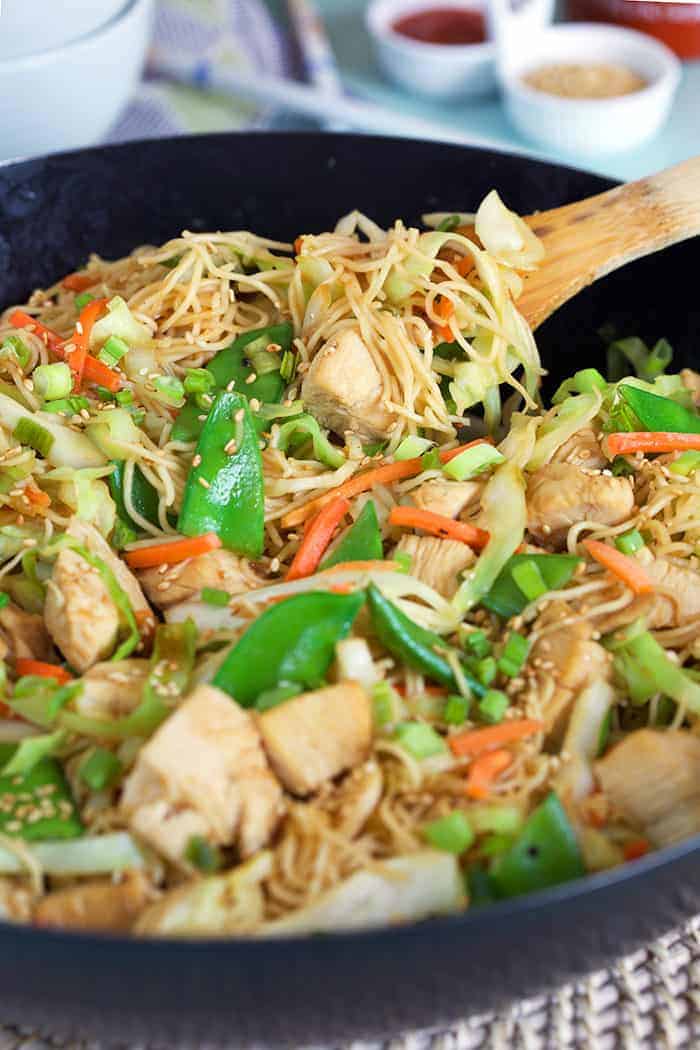 Chicken chow mein in a bowl with some being scooped out