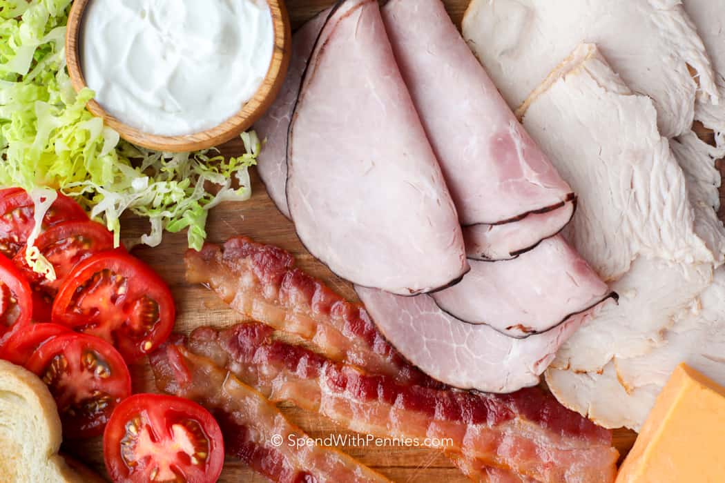 Ingredients for club sandwich on a wooden board