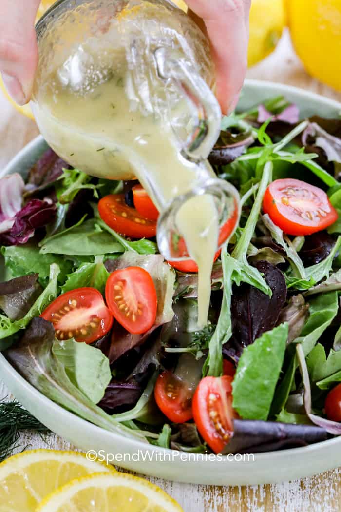 Lemon Vinaigrette being poured onto a salad