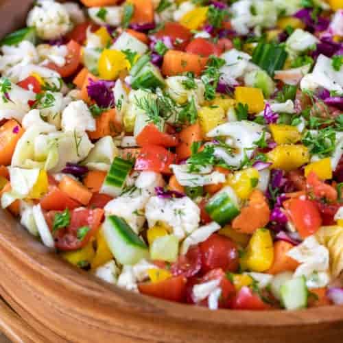 Marinated Veggie Salad in a bowl with dill and parsley
