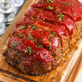 sliced meatloaf on a wood board