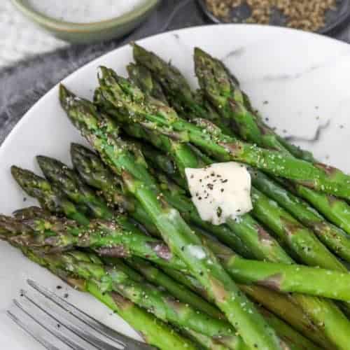 Asparagus on a plate with a fork