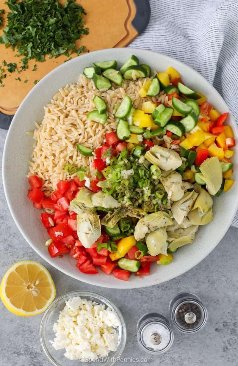 Ingredients for Mediterranean Orzo Salad in a serving bowl