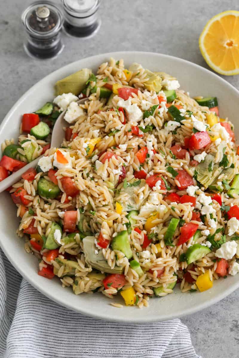 Mediterranean Orzo Salad in a serving bowl with a spoon