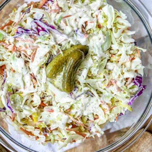 dill pickle coleslaw garnished with pickles