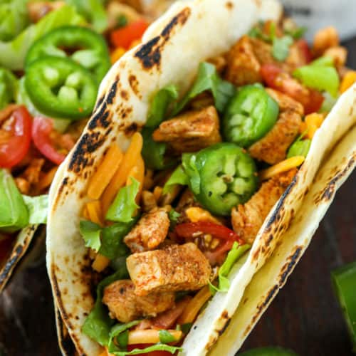Chicken tacos with jalapenos and lettuce
