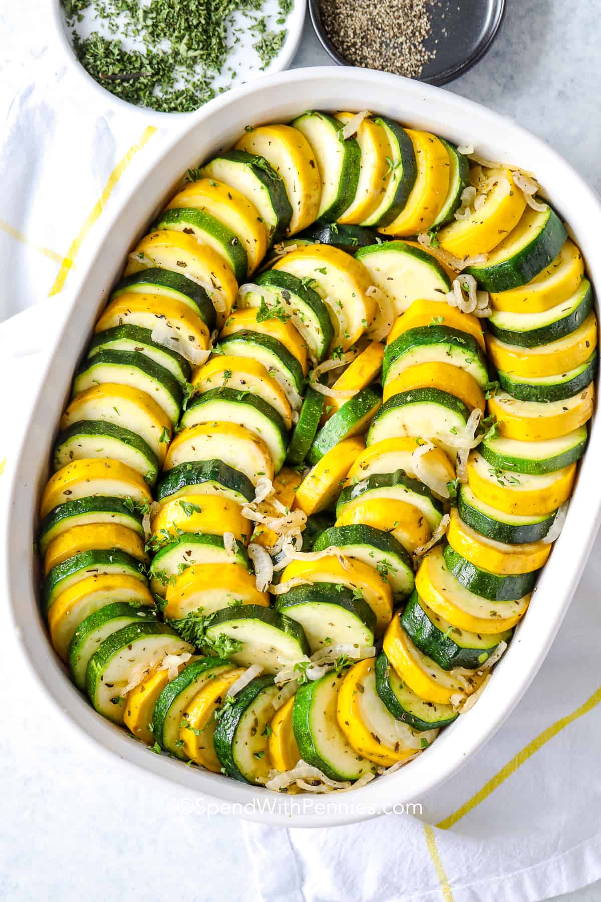 squash casserole in a white baking dish ready to be cooked