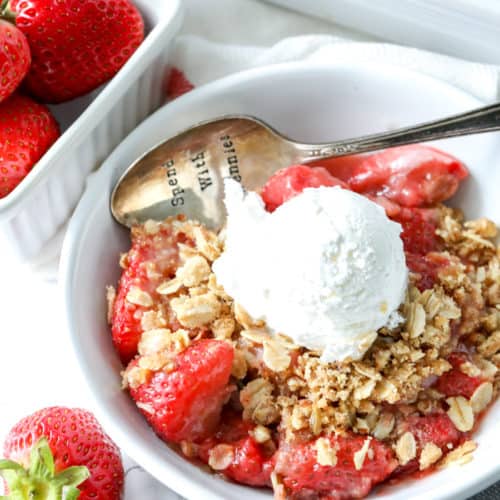 Strawberry Crisp with a vanilla ice cream in a bowl with a spoon