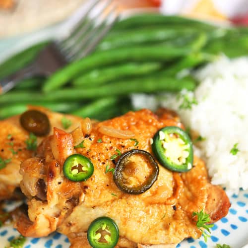 Chicken adobo served with green beans and rice.