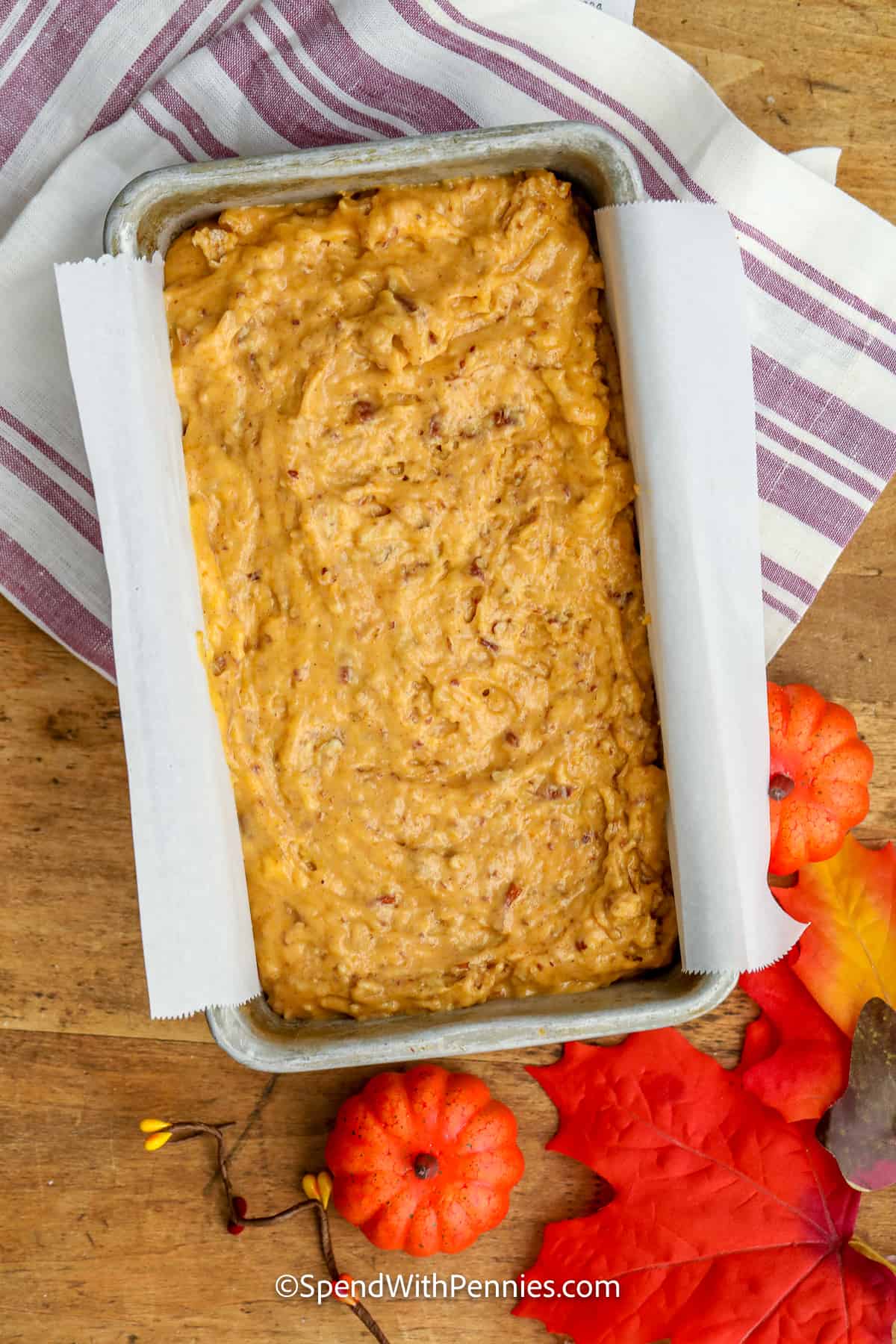 batter for pumpkin bread in a parchment lined loaf pan
