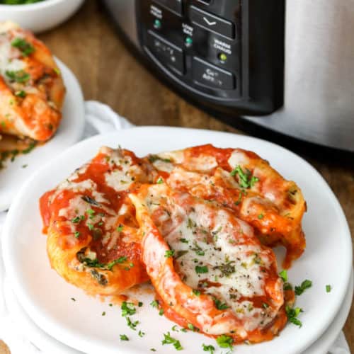 Crock Pot Stuffed Shells on a white plate garnished with parsley
