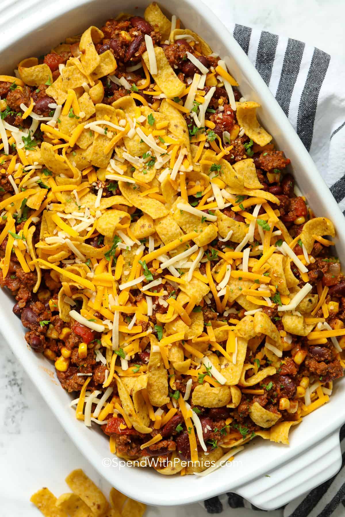 layering frito pie in a casserole dish