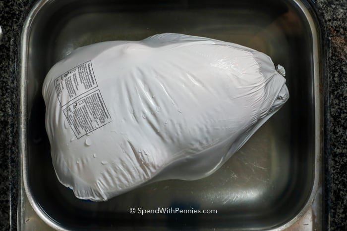 a turkey wrapped from the store in a tub