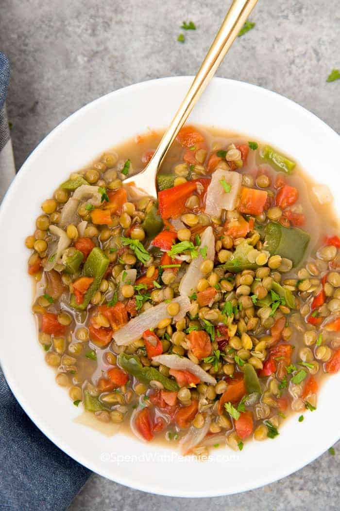 Overhead shot of Lentil Soup in a white bowl with silver spoon
