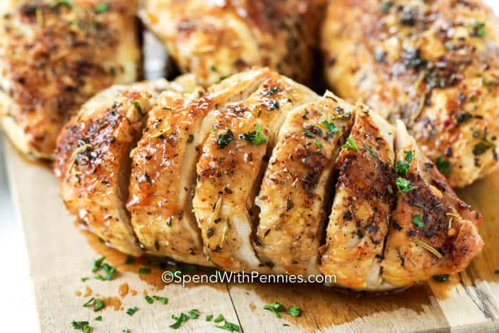 Sliced chicken breast on a wooden board