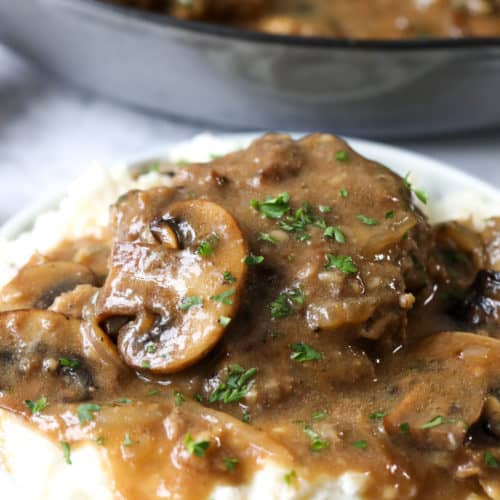 Hamburger steaks on mashed potatoes with parsley