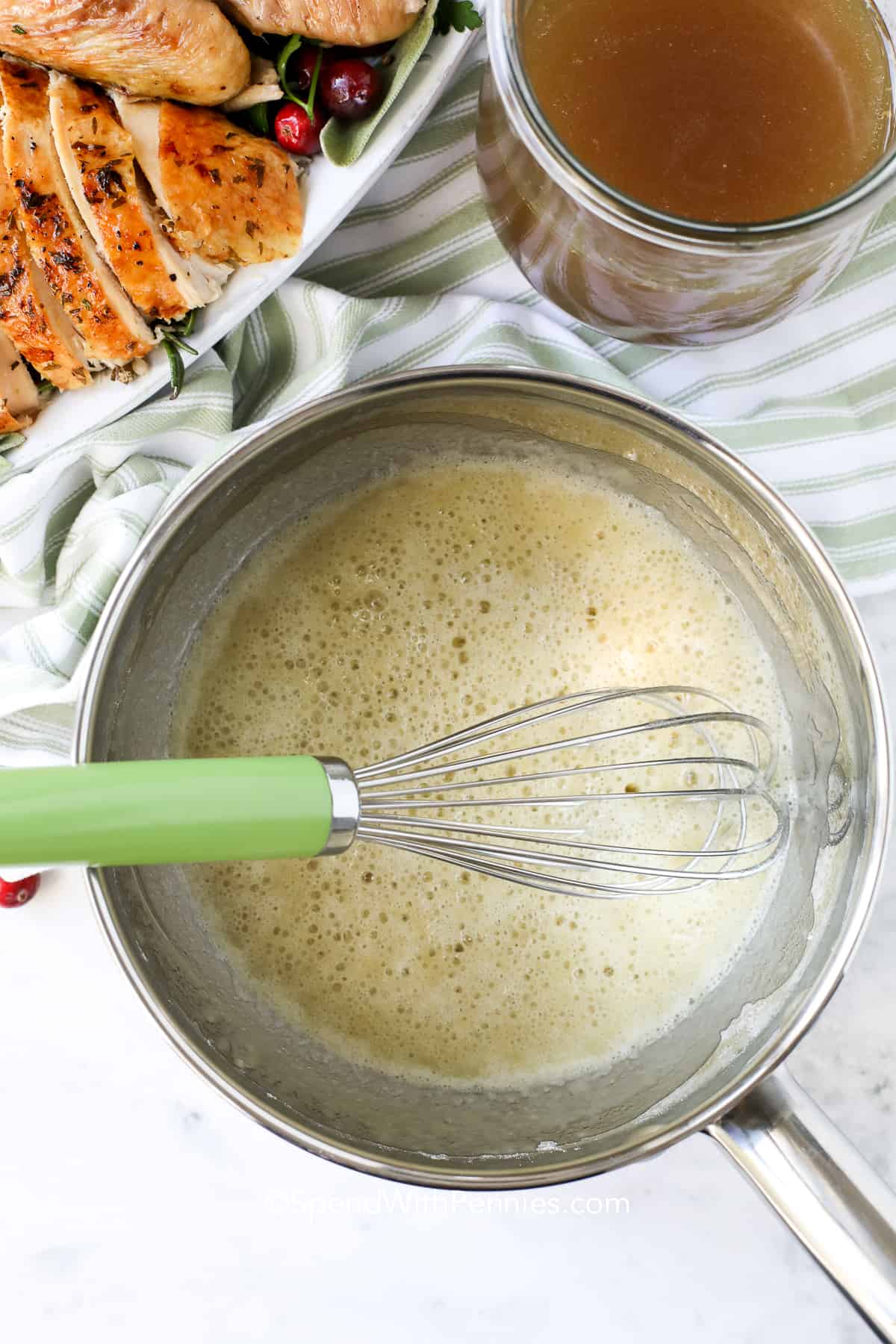 Everyone loves this gravy recipe for its deep, savory flavor made from simple ingredients. Use the fat from chicken, turkey, or beef drippings, cook with flour to form a roux, and gradually whisk in broth until smooth. Add mushrooms or fresh herbs for an extra layer of flavor. Serve over biscuits, roast meats, or steak for an easy, elegant addition to any meal. #spendwithpennies cooking fat and flour in a pot making gravy