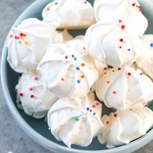 a bowl of white French meringue cookies