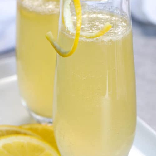 French 75 in glasses with lemon peel as garnish
