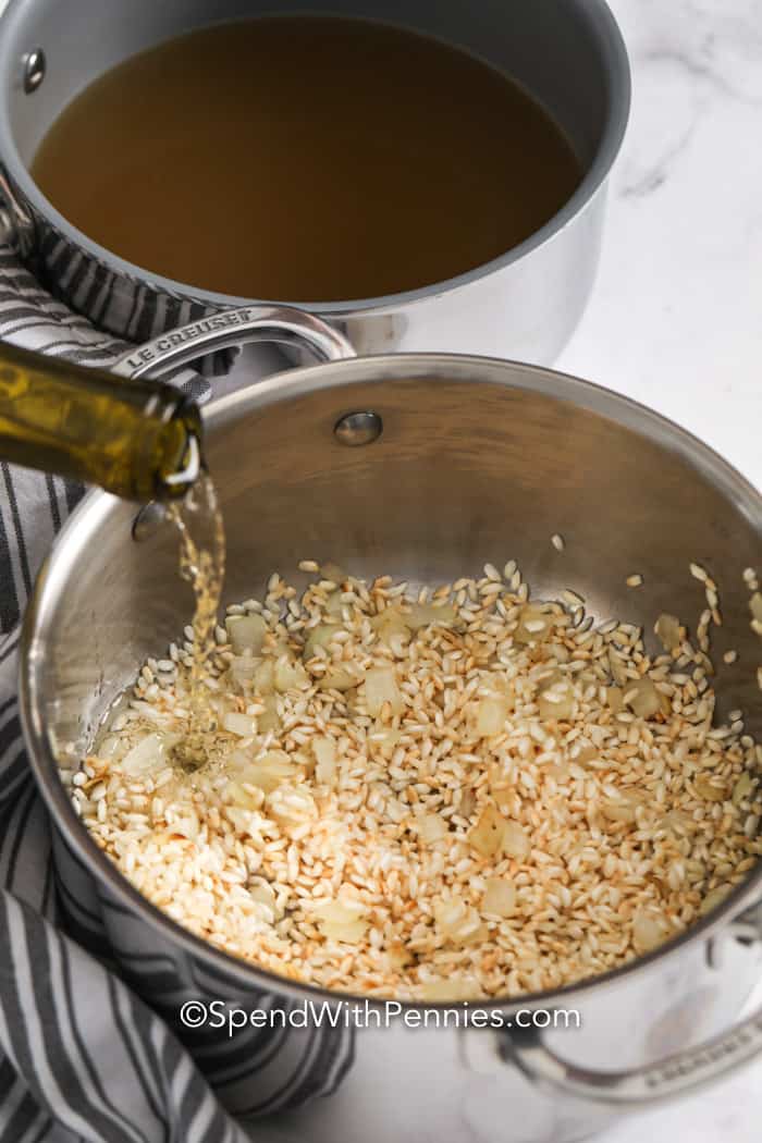 Parmesan risotto is a rich, creamy dish that’s loved for its velvety texture and comforting flavor. The Arborio rice slowly simmers with broth, onions, and garlic, creating a smooth, buttery consistency. A splash of wine adds depth, while Parmesan brings the perfect cheesy finish. It’s easy to make yet feels fancy, making it great for weeknights or special occasions. Whether served with chicken, seafood, or veggies, it’s always a crowd-pleaser! #spendwithpennies Ingredients for Parmesan Risotto in a pot