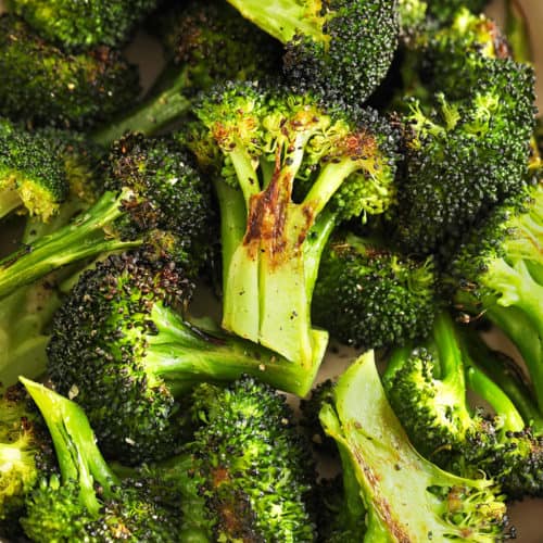 Close up of garlic roasted broccoli in a serving dish.