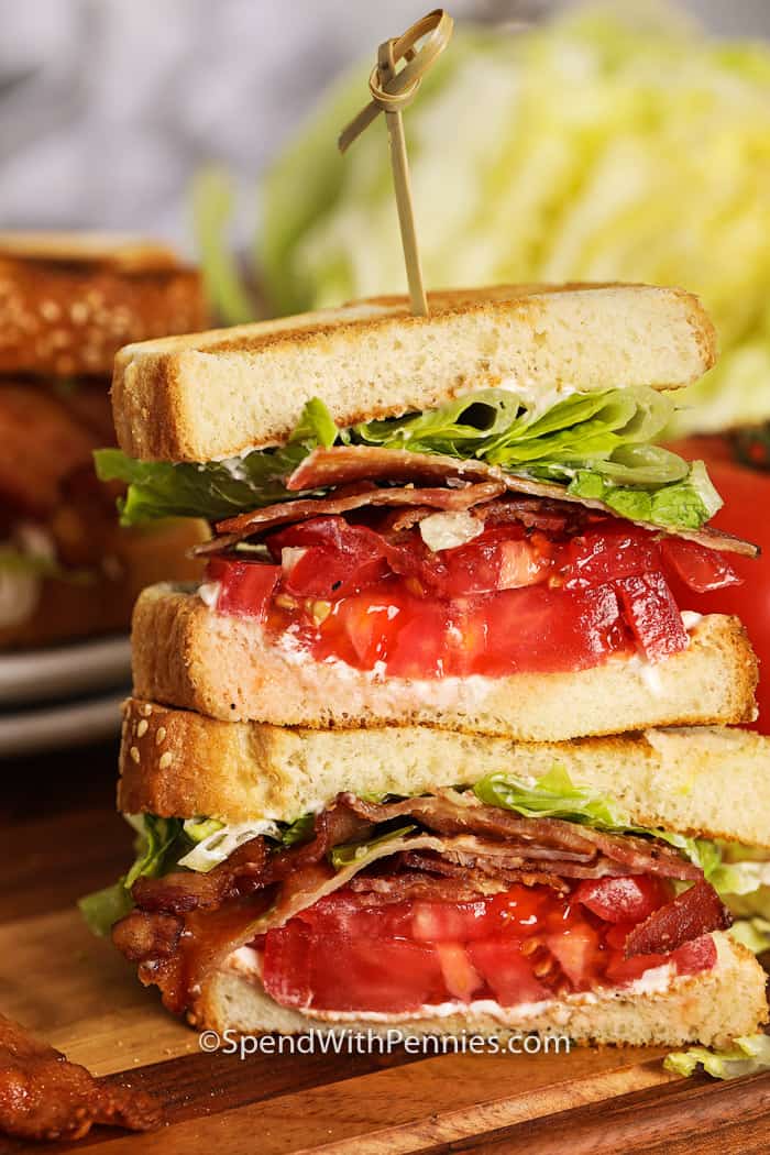 BLT sandwiches are a classic! They're made with crispy bacon, fresh lettuce and juicy tomatoes, all stacked between two thick slices of perfectly toasted bread. The bacon adds a hearty crispiness, while the lettuce and tomatoes add refreshing flavors. BLT sandwiches are a simple yet filling option for a delicious lunch or snack. #bltsandwich #blt #sandwich #spendwithpennies Using a stick, cut the BLT sandwich in half