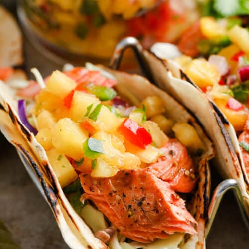 Salmon Tacos with Pineapple Salsa closeup of taco with salsa behind