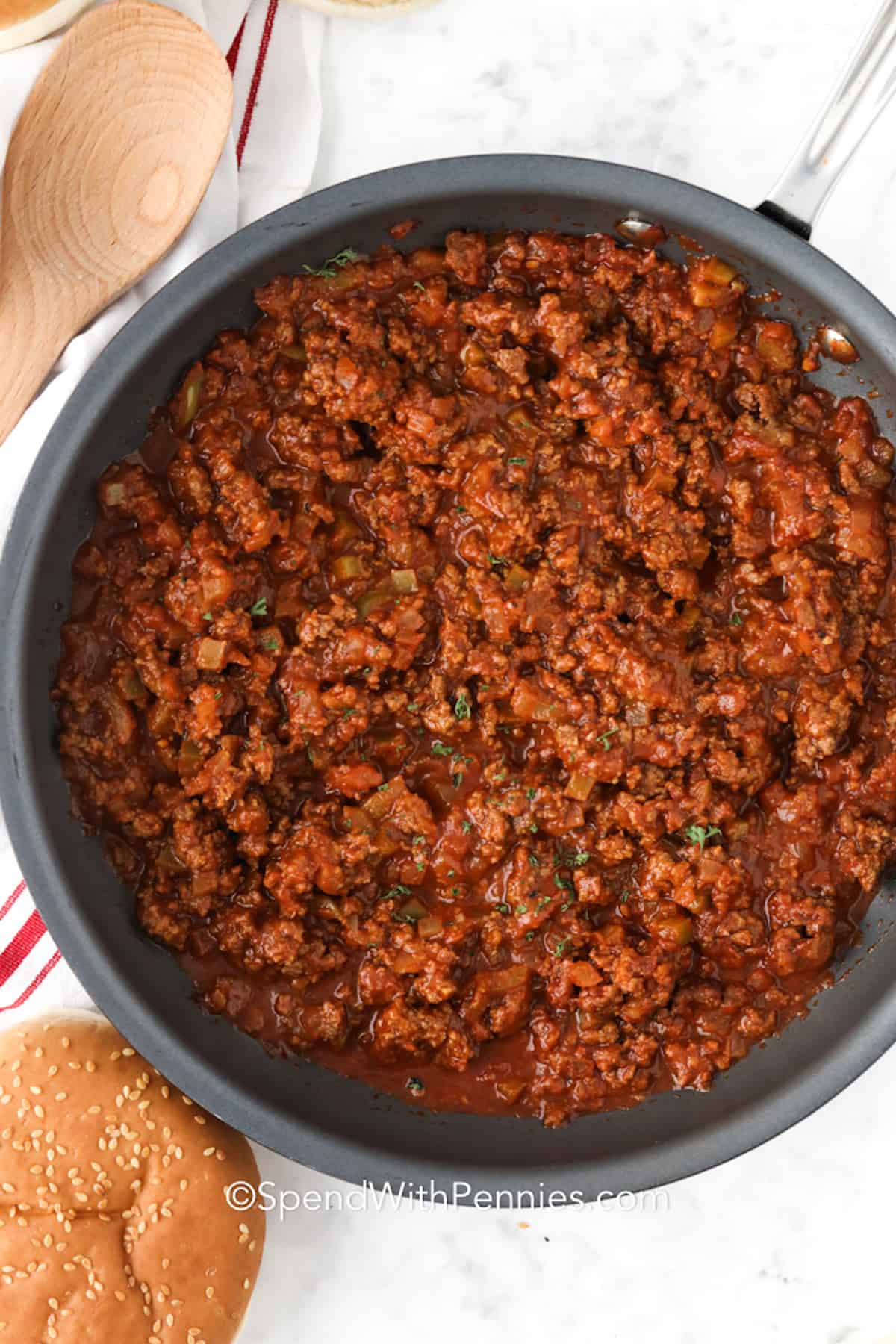 Make this Sloppy Joe recipe your new go-to meal! With lean ground beef, peppers, and a rich, savory sauce, it’s full of flavor and ready fast. Perfect for family dinners or parties; keep it warm in the Crockpot and let everyone serve themselves. Freeze leftovers for quick, delicious meals anytime. Served on toasted buns, this recipe brings everyone back for seconds! #spendwithpennies cooked sloppy joes in a skillet
