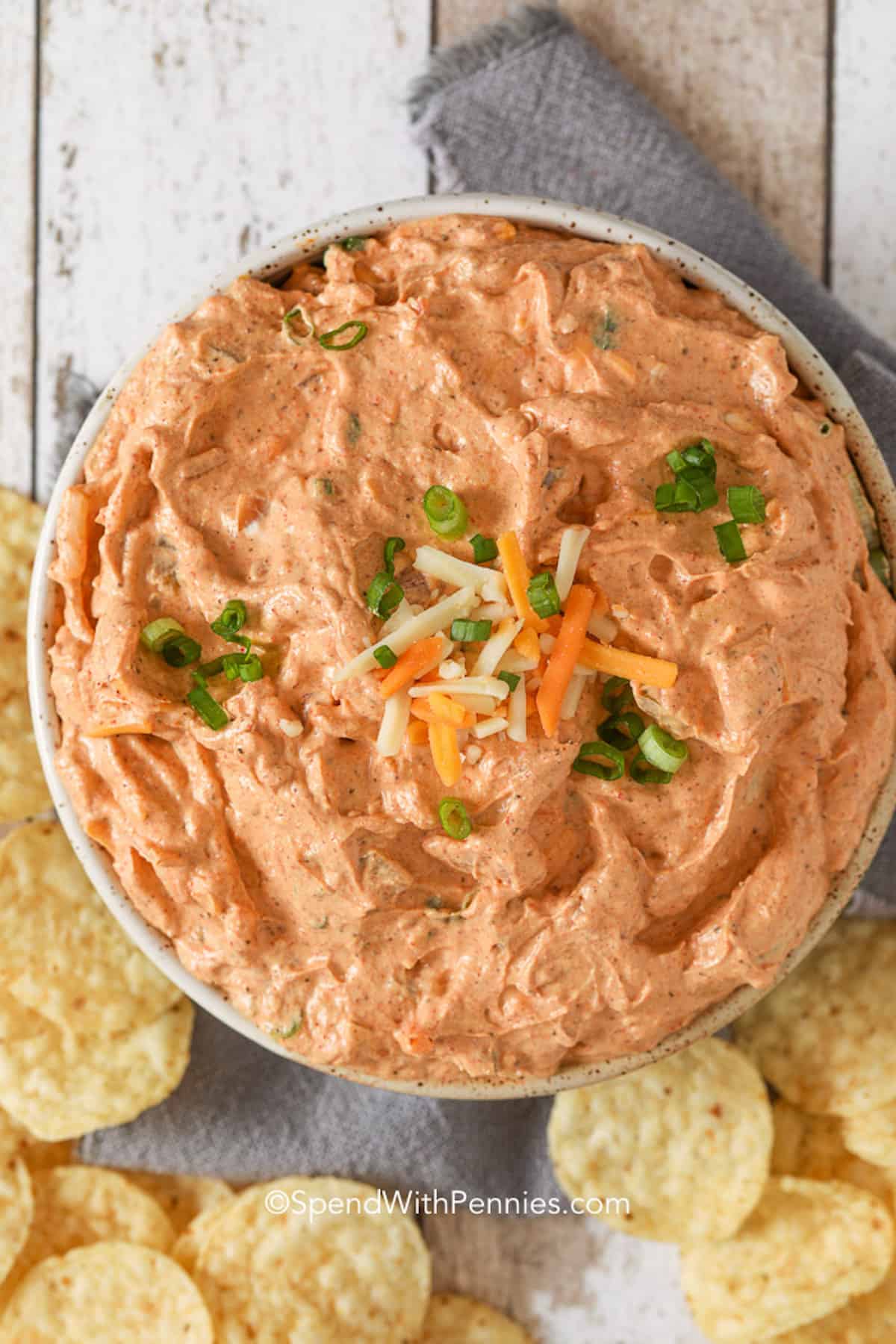 Cream cheese salsa dip in a bowl with tortilla chips underneath